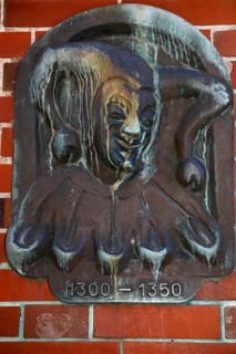 Metal sign by Till Eulenspiegel on a house in the old town of Moelln
