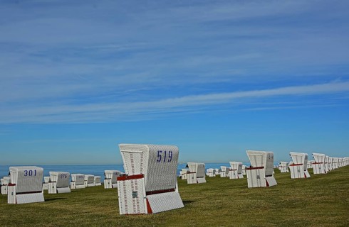 White beach chairs at the dike