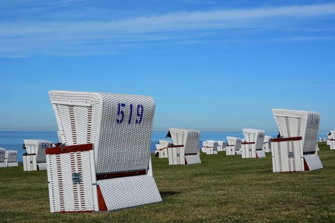 White beach chairs at the dike
