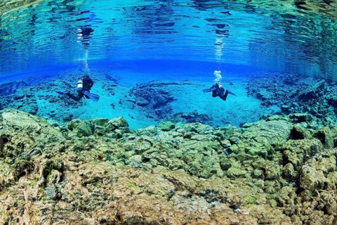 Two divers in the Silfra Lagoon