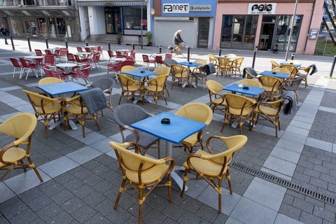 Empty tables and chairs in front of a restaurant