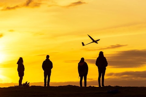People with model airplane on the Breitenstein