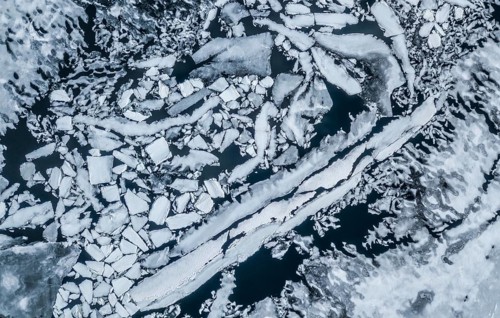 Partly frozen lake with ice floes