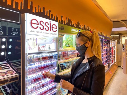 Woman wearing a face mask while shopping in the cosmetics department
