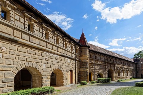 Fortress wall with small tower and arcades