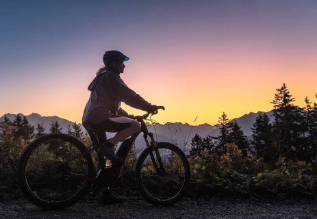 Silhouette of a female mountain biker in dusk