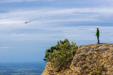 Man with model airplane on the Breitenstein