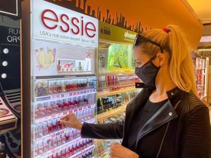 Woman wearing a face mask while shopping in the cosmetics department
