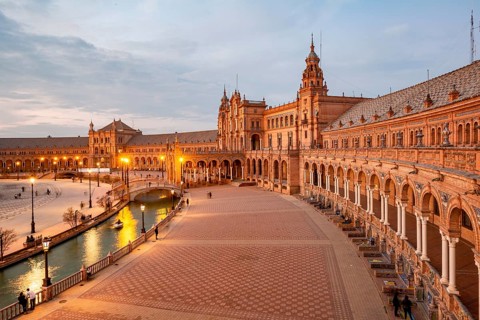 View over the illuminated Plaza de Espana at dusk Panorama