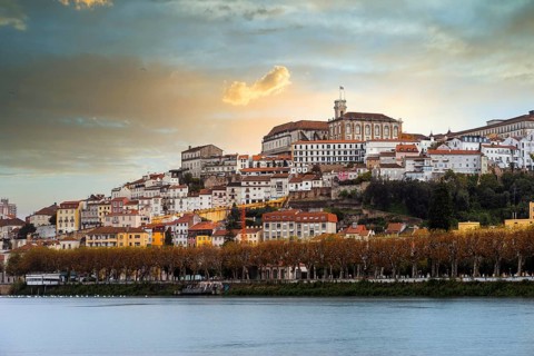 Coimbra cityscape with Mondego river by sunset