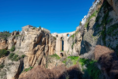 Bridge Puente Nuevo with waterfall at steep cliffs