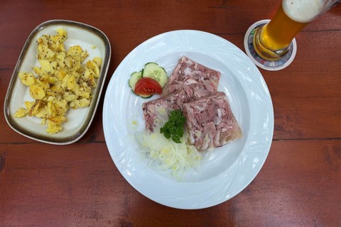 Brawn with fried potatoes and wheat beer on a beer table