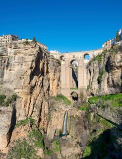 Bridge Puente Nuevo with waterfall at steep cliffs