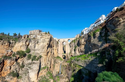 Bridge Puente Nuevo with waterfall at steep cliffs