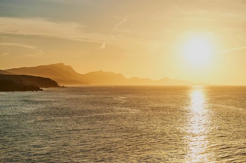 Rocky coast near beach Playa de la Pared at sunset