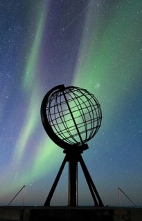 Steel globe at North Cape with northern lights