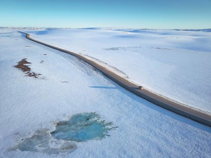 Lonely road to the North Cape in snow covered arctic landscape with motorhome