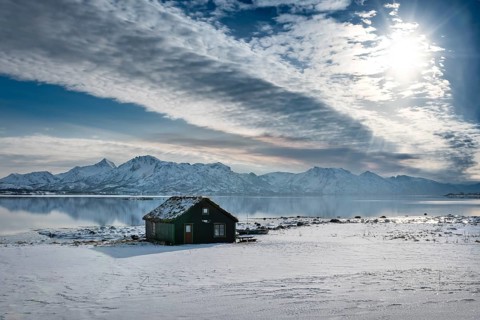 Wooden house in winter landscape