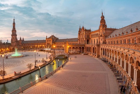View over the illuminated Plaza de Espana at dusk Panorama