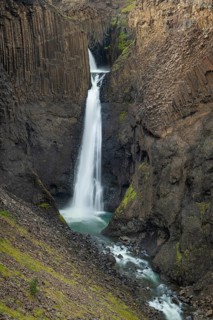 Waterfall Litlanesfoss between columnar basalt