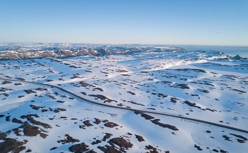 Lonely road to the North Cape in snow covered arctic landscape by car