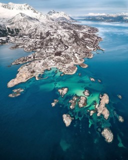 Aerial view of Senjehestneset bay with offshore archipelago islands and turquoise sea bed