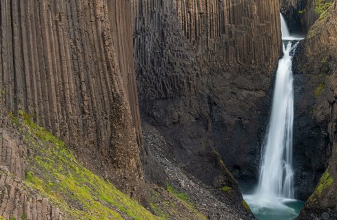Waterfall Litlanesfoss between columnar basalt