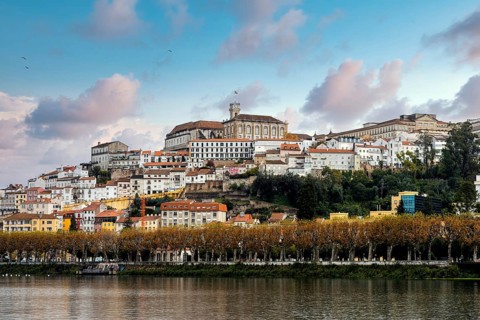Coimbra cityscape with Mondego river by sunset