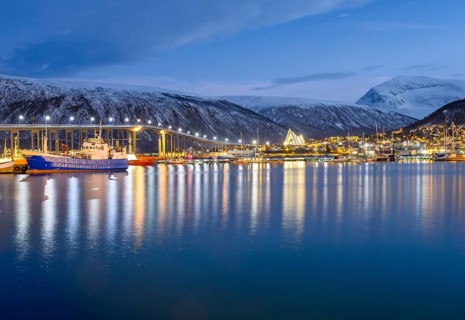 View over the harbour and city with Tromsobrua or Tromso Bridge
