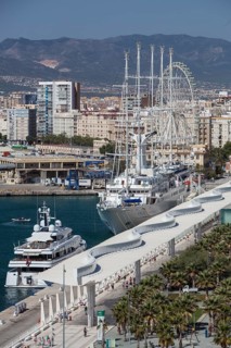 Luxury yachts and Palmeral De Las Sorpresas in the port of Malaga