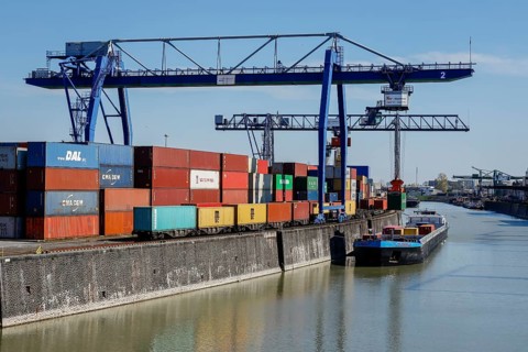 Harbour crane loads container ship with containers