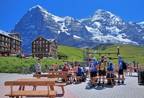 Tourists and hikers on Kleine Scheidegg in front of the Eiger and Moench