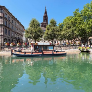 Historic boat on de Ill in front of the Palais Rohan