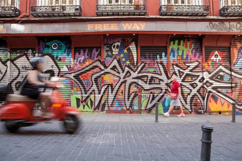 Row of shops with graffiti in the Malasana district