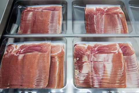 Cured ham being packaged