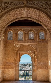 View of the Albayzin district through arched windows decorated with arabesques