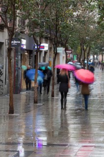 Residents and tourists walk by the most famous Fuencarral street