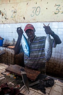 Somali man offering his fish in the Fishmarket