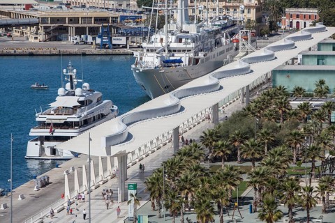 Luxury yachts and Palmeral De Las Sorpresas in the port of Malaga