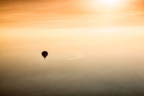 Hot air balloon rides towards sunset