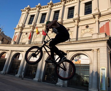 Youngster with BMX in front of the Real Theater