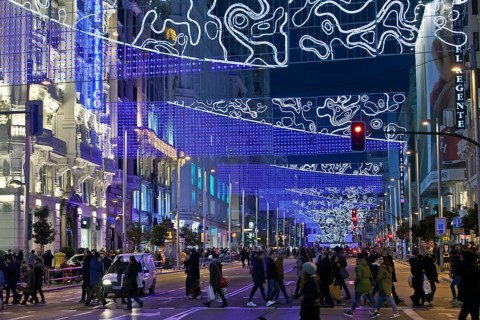 Pedestrians in La Gran Via with Christmas lights