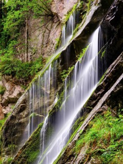 Waterfall on mossy rock face