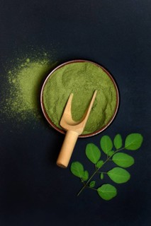 Moringa powder in bowl and Moringa leaves