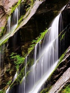 Waterfall on mossy rock face