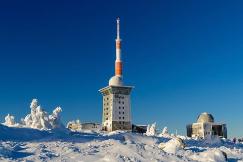 Transmitter mast and Brocken hostel on the winter snow-covered Brocken