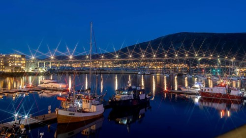 Blue hour in the port of Tromsoe with the bridge