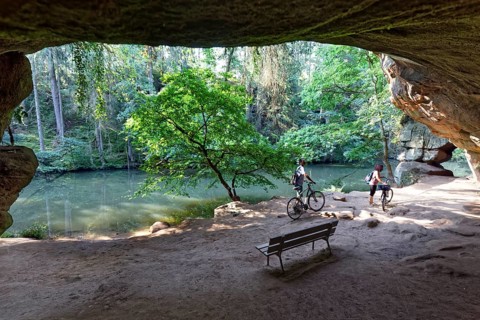 Bank and cyclist in front of Gutav Adolf cave