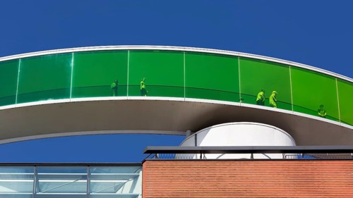 Visitors in the panorama corridor with green windows