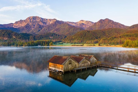 Boathouses in the Lake Kochel near Schlehdorf in the morning light